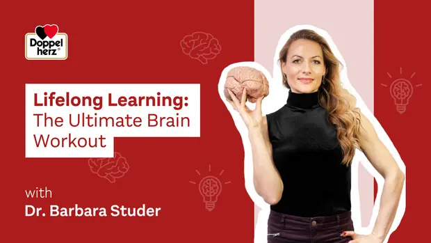 A woman in a black top holds a brain model in her left hand, promoting "Lifelong Learning: The Ultimate Brain Workout" with Dr. Barbara Studer. The background features light and dark red colors with brain and light bulb icons, emphasizing the theme of mental fitness and education.